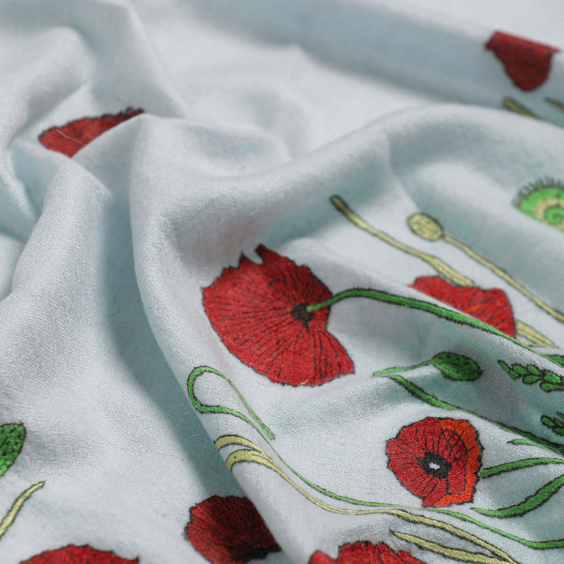 Close-up of the fine hand embroidery on handwoven cashmere, Poppy Ivory Butidar Radial Dye Shawl